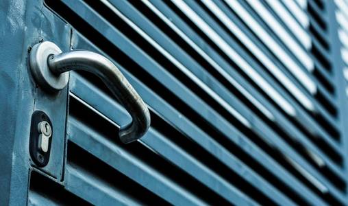 blue colored gate with a lock handle